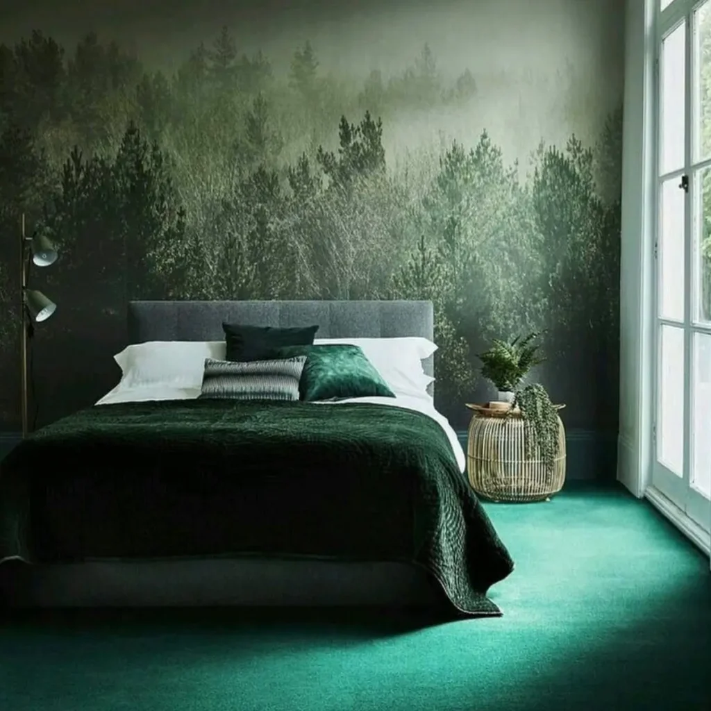 A moody nature-inspired bedroom featuring a large, dark green forest mural behind a bed with velvet bedding.