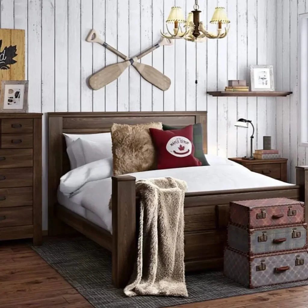 A country rustic bedroom with a dark wood bed set against a white shiplap wall decorated with crossed oars.