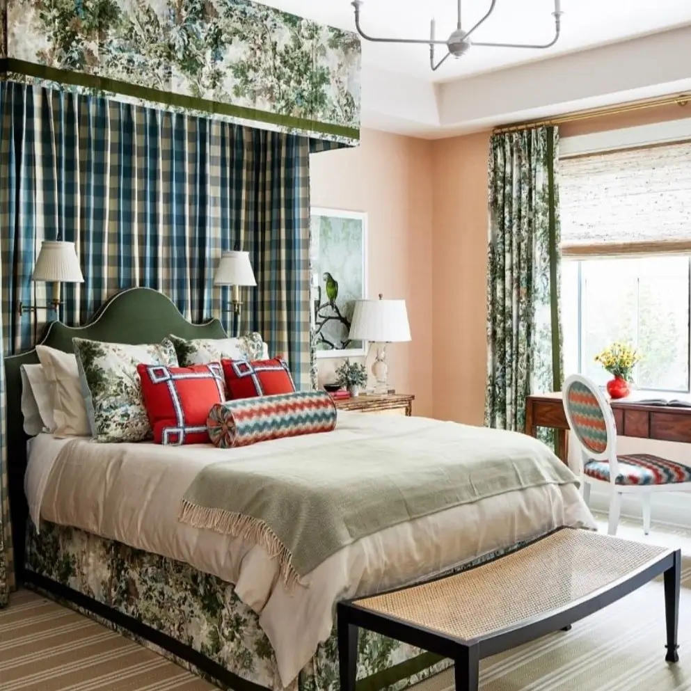 A traditional nature-inspired bedroom mixing a green foliage-patterned fabric with blue plaid on a canopy bed.