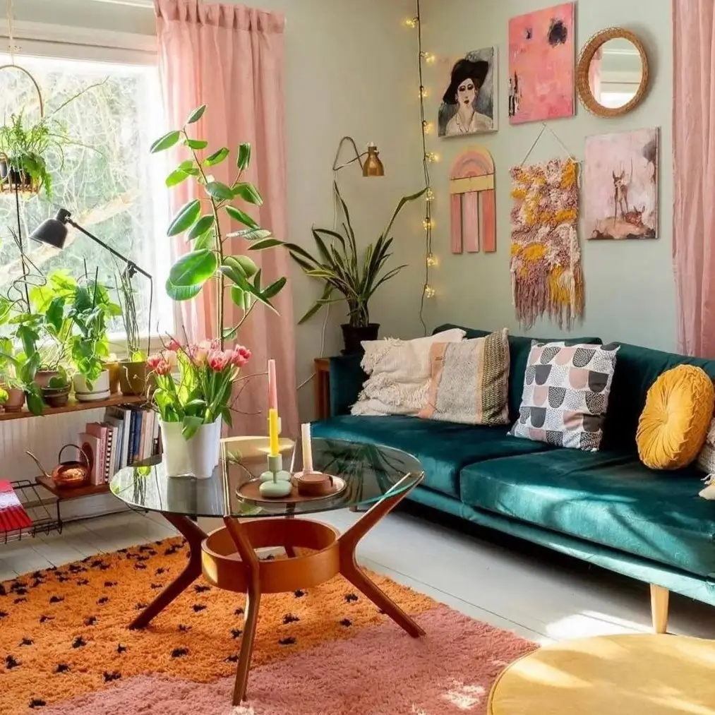A sunlit bohemian living room featuring a teal velvet sofa, a bright orange rug, eclectic wall art, and an abundance of houseplants.