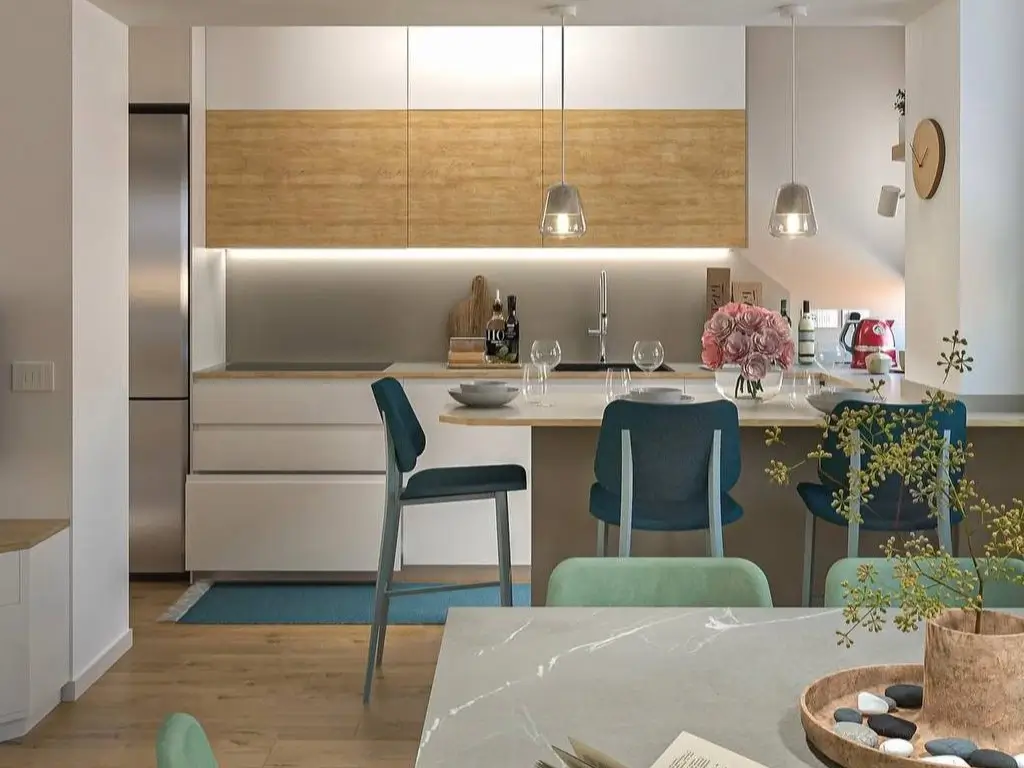 A modern small kitchen design with two-tone white and wood cabinets, a dining peninsula, and pendant lighting.