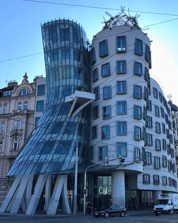 An architectural idea of a modern building with dynamic, fluid glass curves contrasting with a solid tower.