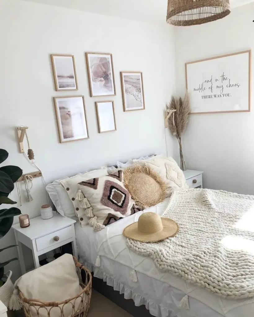 A bright boho bedroom with a gallery wall of five coastal prints and a large framed quote hanging above the bed.
