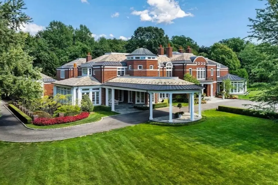 The Ultimate Guide to Luxury Mansion Design: 33 Ideas for Grandeur 14 A stately red brick mansion with an elegant, curved porte-cochère and central rotunda.