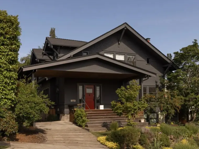 A classic Craftsman-style home updated with a contemporary deep charcoal exterior paint color.