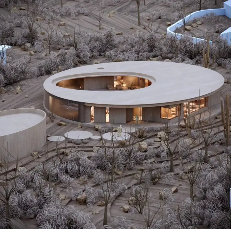 A modern circular home design idea with a central open-air courtyard set in a desert landscape.