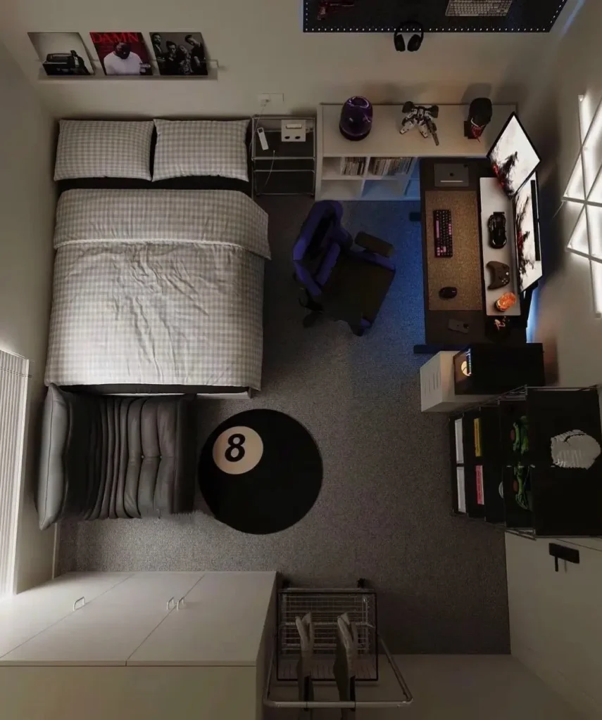 A small bedroom interior design from above, showing a bed with gingham sheets next to a modern gaming desk setup with glowing lights.
