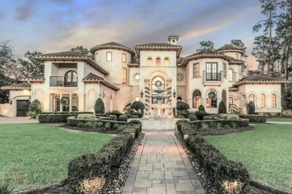 The Ultimate Guide to Luxury Mansion Design: 33 Ideas for Grandeur 26 A romantic Mediterranean-style mansion with a formal, hedge-lined walkway to a fountain.