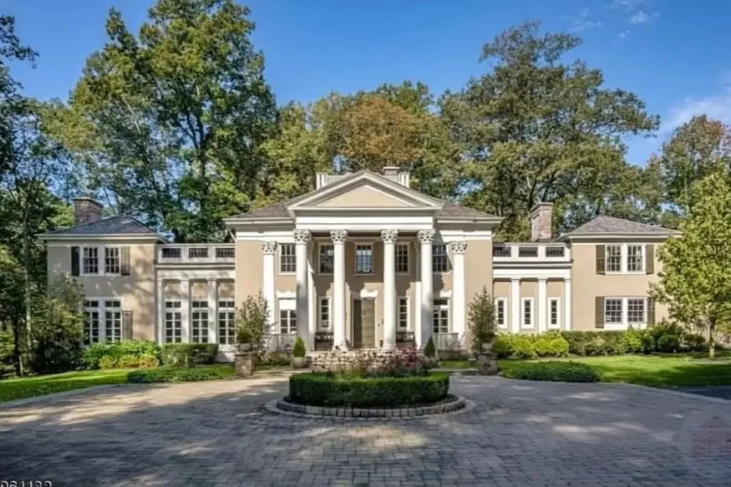 The Ultimate Guide to Luxury Mansion Design: 33 Ideas for Grandeur 28 A symmetrical neoclassical mansion with a grand columned portico and circular driveway.