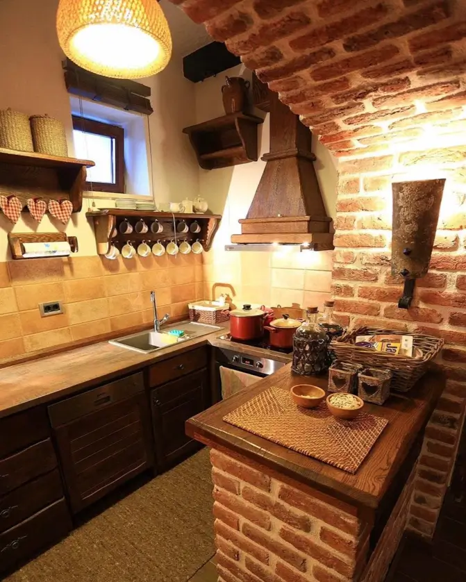 A simple rustic kitchen idea featuring a prominent brick archway over the stove and dark wood cabinetry in a cozy nook.