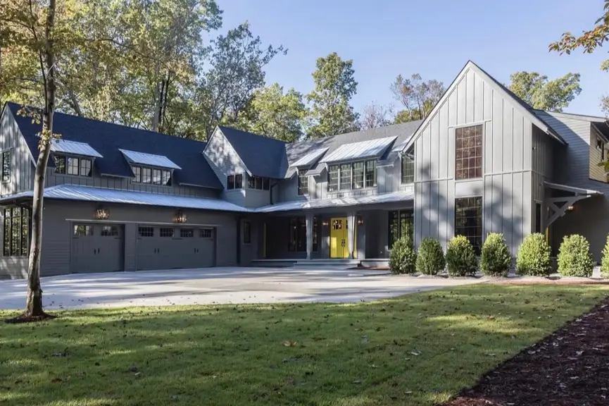 A large, modern home in a sophisticated charcoal gray color, showcasing a softer take on the black house design trend.