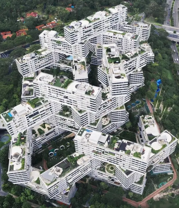 Aerial view of a stacked geometric architectural concept, forming a 'vertical village' with interconnected blocks.