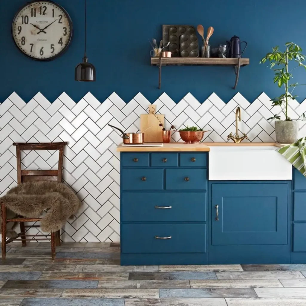 A modern rustic kitchen design idea featuring bold blue shaker cabinets, a farmhouse sink, and warm butcher block countertops.