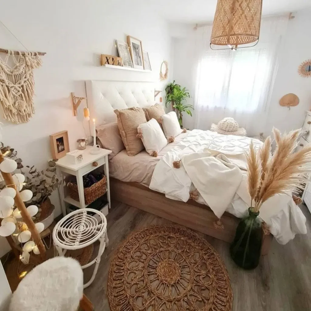 A bright, bohemian-style bedroom featuring a jute rug, a rattan pendant light, and layers of textured neutral bedding.
