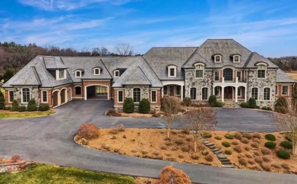 The Ultimate Guide to Luxury Mansion Design: 33 Ideas for Grandeur 11 A sprawling stone and brick country mansion with a functional porte-cochère.