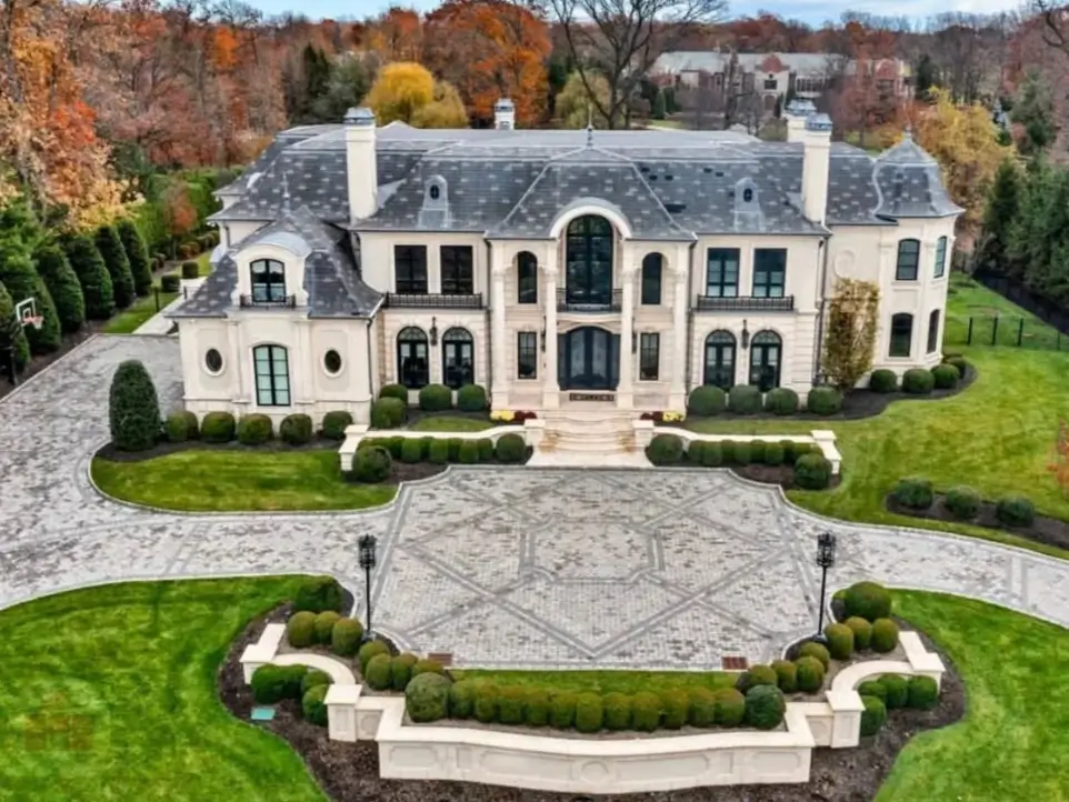 The Ultimate Guide to Luxury Mansion Design: 33 Ideas for Grandeur 12 An aerial view of a luxury mansion with an intricate, patterned paver driveway.