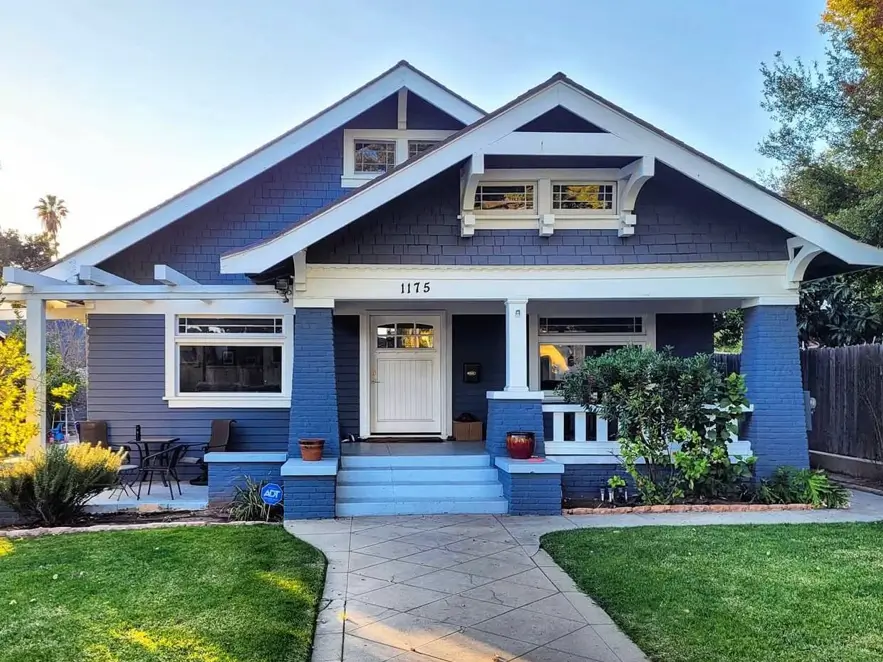 A beautiful blue craftsman house exterior with a welcoming front porch and crisp white trim.