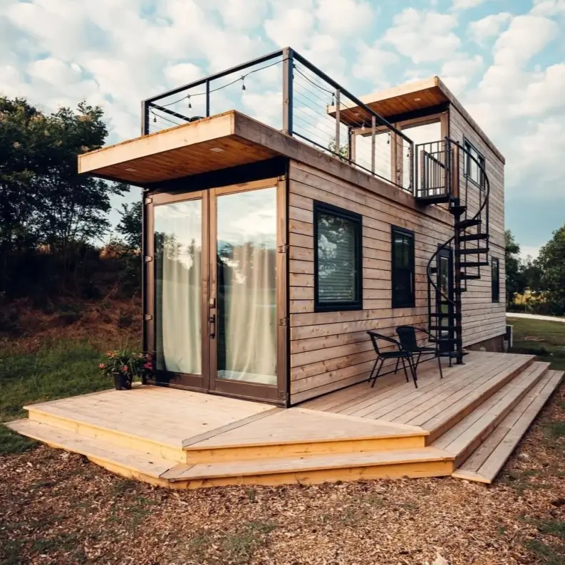 A two-story tiny container house design with light wood siding, a black spiral staircase, and a rooftop terrace.