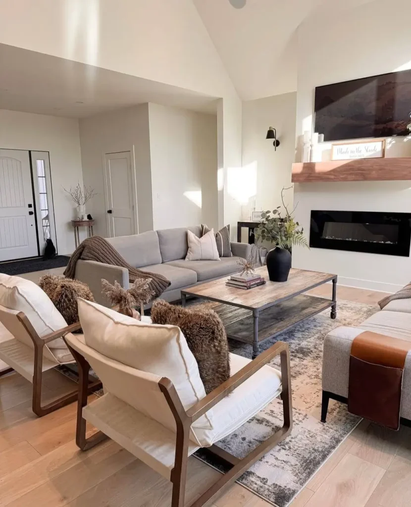 Modern farmhouse living room with a linear fireplace, floating wood mantel, and modern wood-frame chairs.