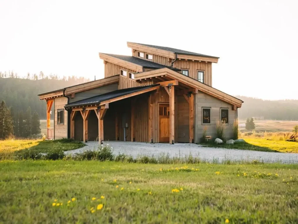 A stunning house design featuring a modern timber-frame home with a layered roof in a sunlit meadow.