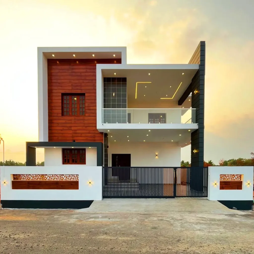 A beautiful modern house design with a white, wood, and dark grey exterior, featuring a glass balcony at sunset.
