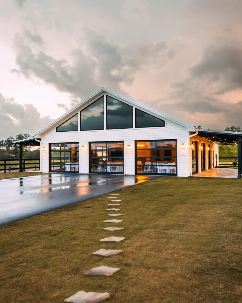 Modern barn-style stunning house design with large glass doors.