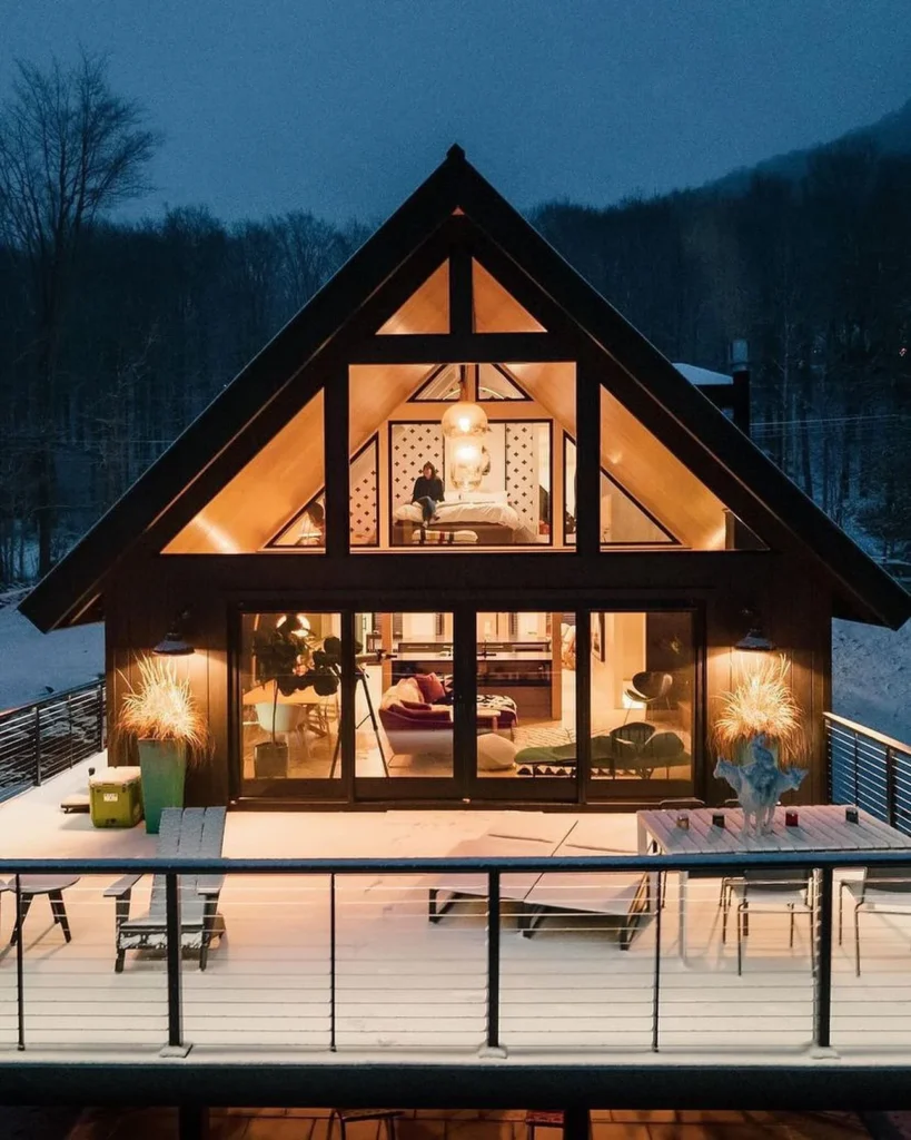 A-frame chalet stunning house designs with large windows in winter.