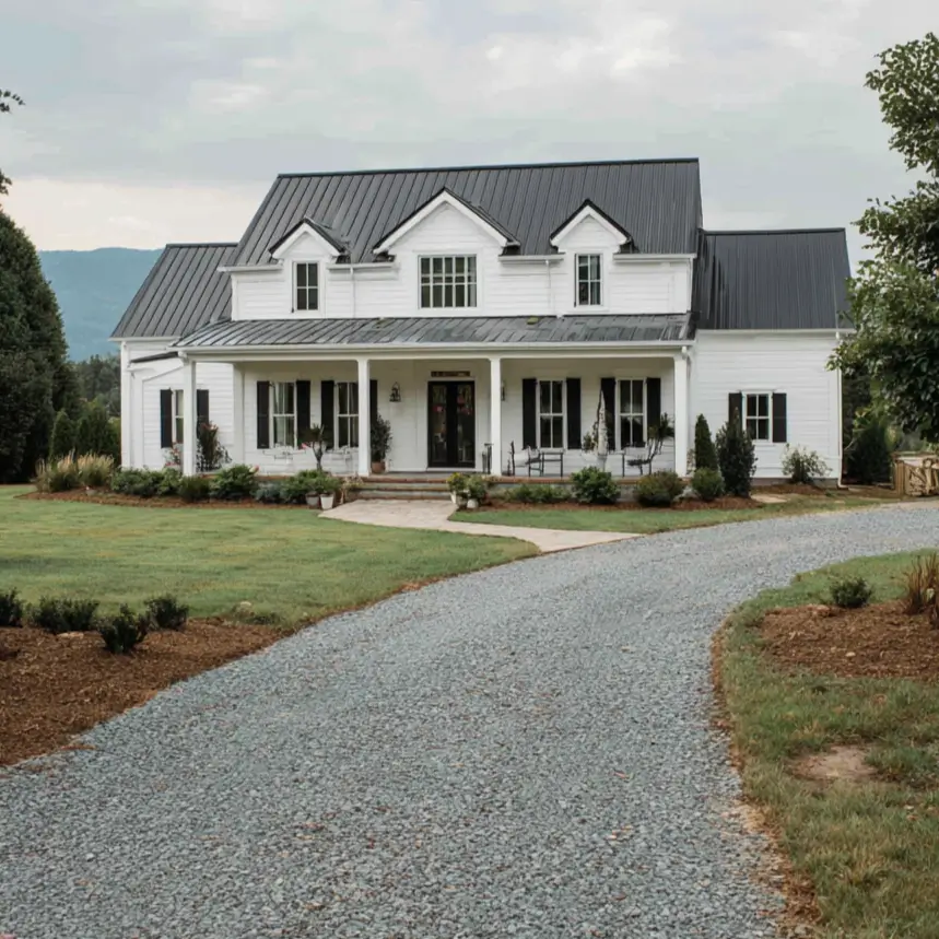 The classic silhouette of a black and white farmhouse with a standing-seam metal roof and black shutters.