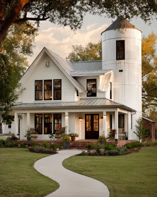 A beautiful white modern farmhouse featuring an integrated grain silo that serves as a multi-story architectural tower.
