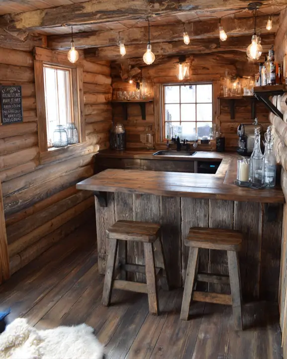 A casual bar log cabin with industrial string lights and a U-shaped wooden bar.