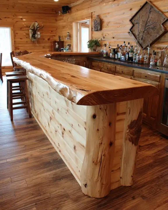 A bright bar log cabin featuring light-colored pine paneling and a live-edge bar.