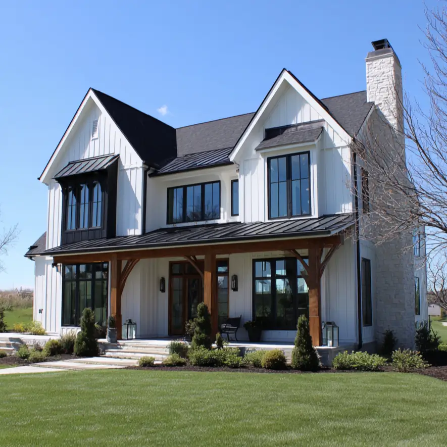 A sophisticated black modern farmhouse with a rustic stone chimney and a porch with exposed timber framing.