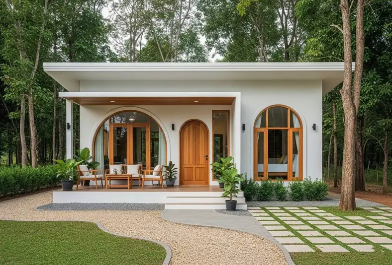A modern white small house with large arched windows and a wooden door, showcasing a unique exterior design idea for small houses.