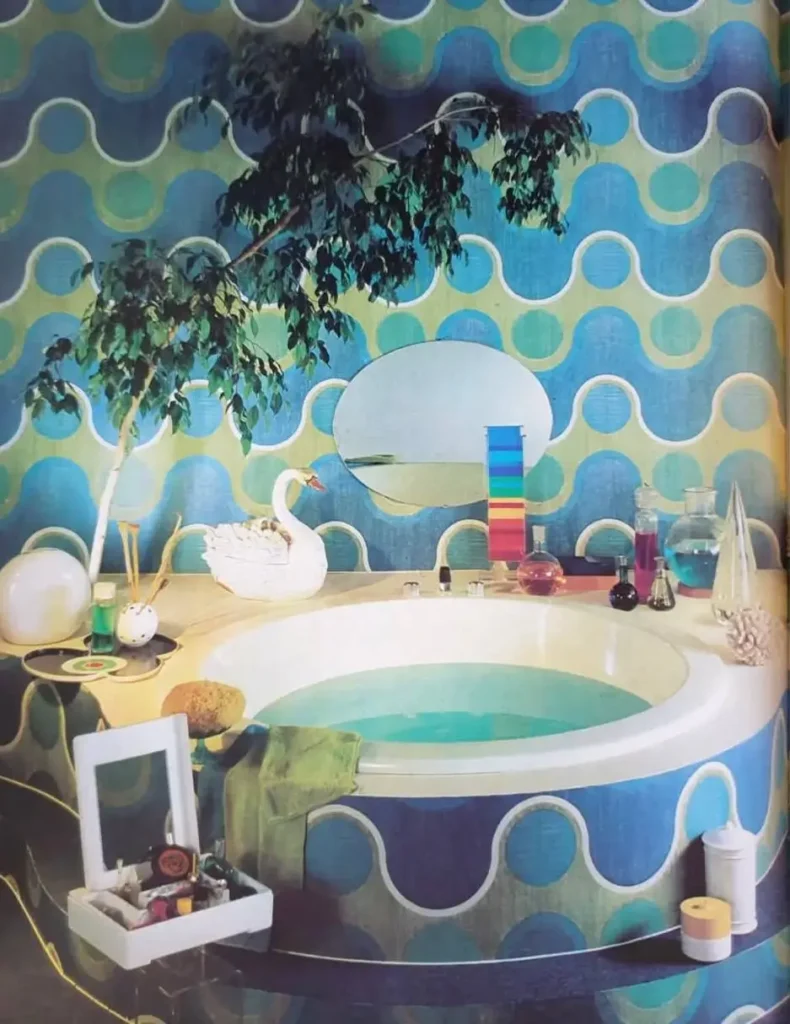 A retro 70s bathroom featuring a bold blue and green wave supergraphic pattern on the walls and tub.
