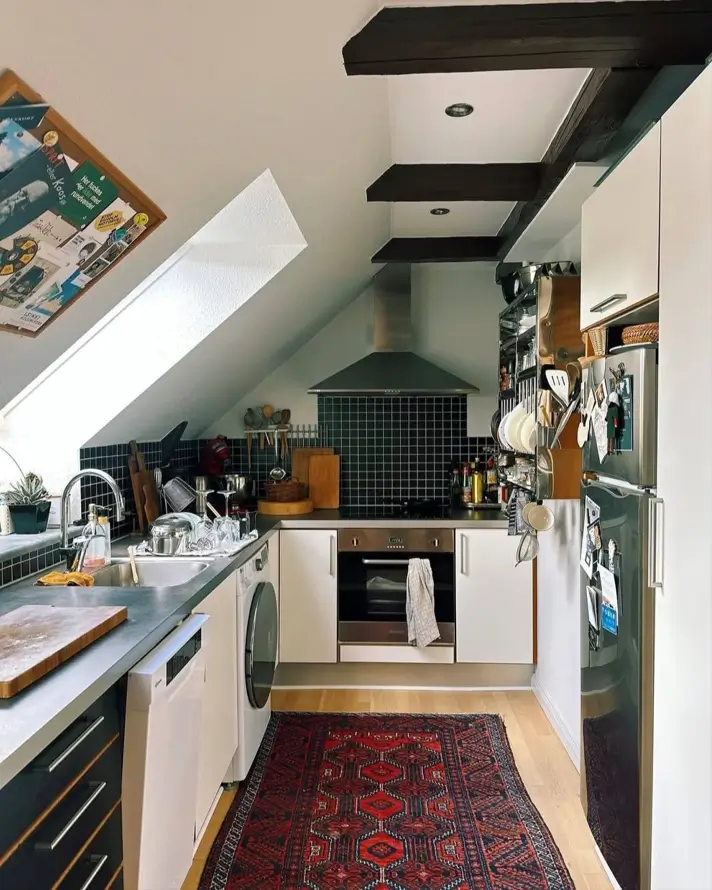 A cozy small apartment attic kitchen featuring a vibrant Persian rug that adds warmth to the modern, compact interior.