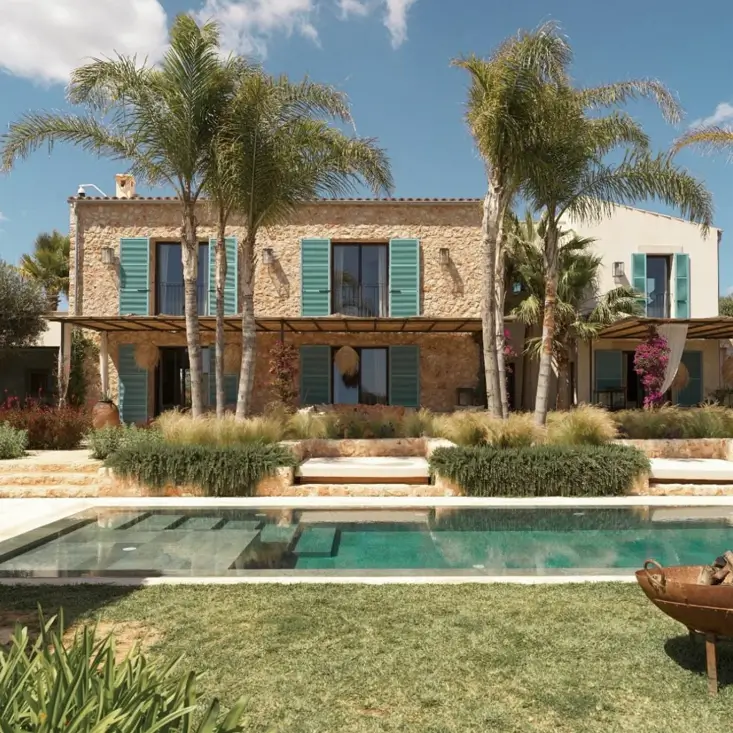 A rustic stone Mediterranean house with vibrant turquoise shutters and a modern rectangular pool.