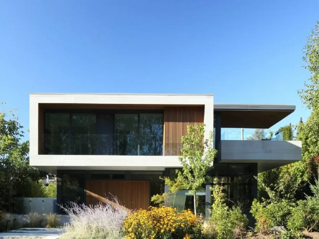 The Chancellor Residence by Frits de Vries Architect Ltd., a modern minimalist house with a floating stone volume and wood slats.