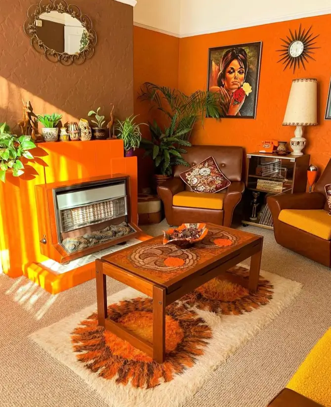 A 70s living room with a mosaic tile coffee table, brown leather chairs, and a bright orange fireplace.