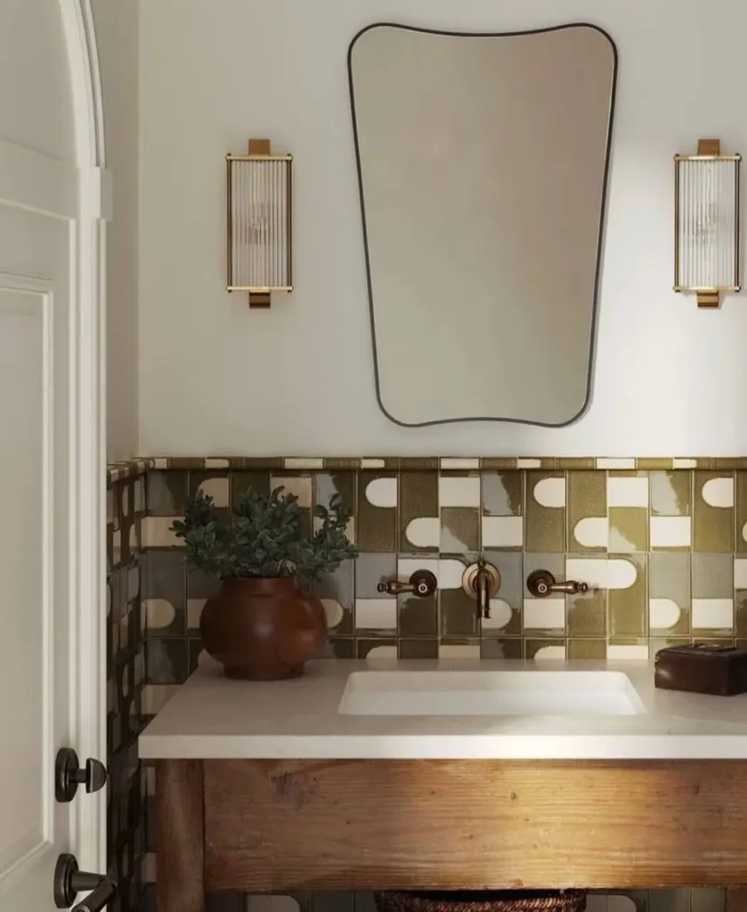 A modern 70s bathroom with a geometric green and white tile backsplash over a rustic wood vanity.