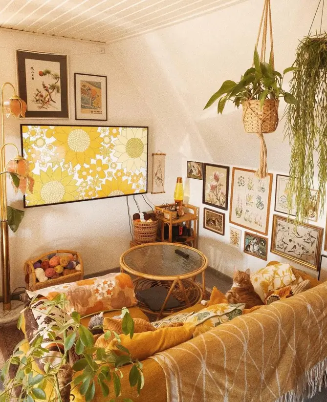 A 70s living room with a harvest gold sofa, rattan coffee table, and botanical gallery wall.