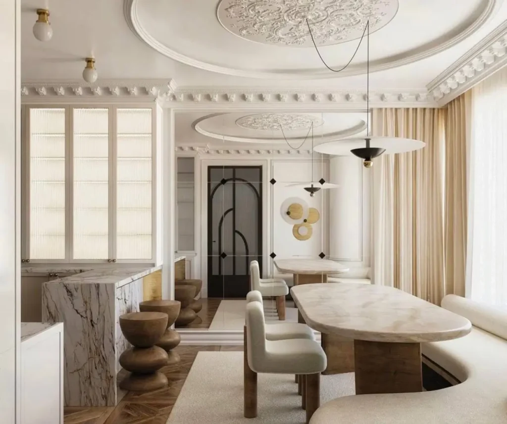 Elegant dining room by Lindsey Goddard Interiors with ornate molding and modern, organic sculptural furniture.