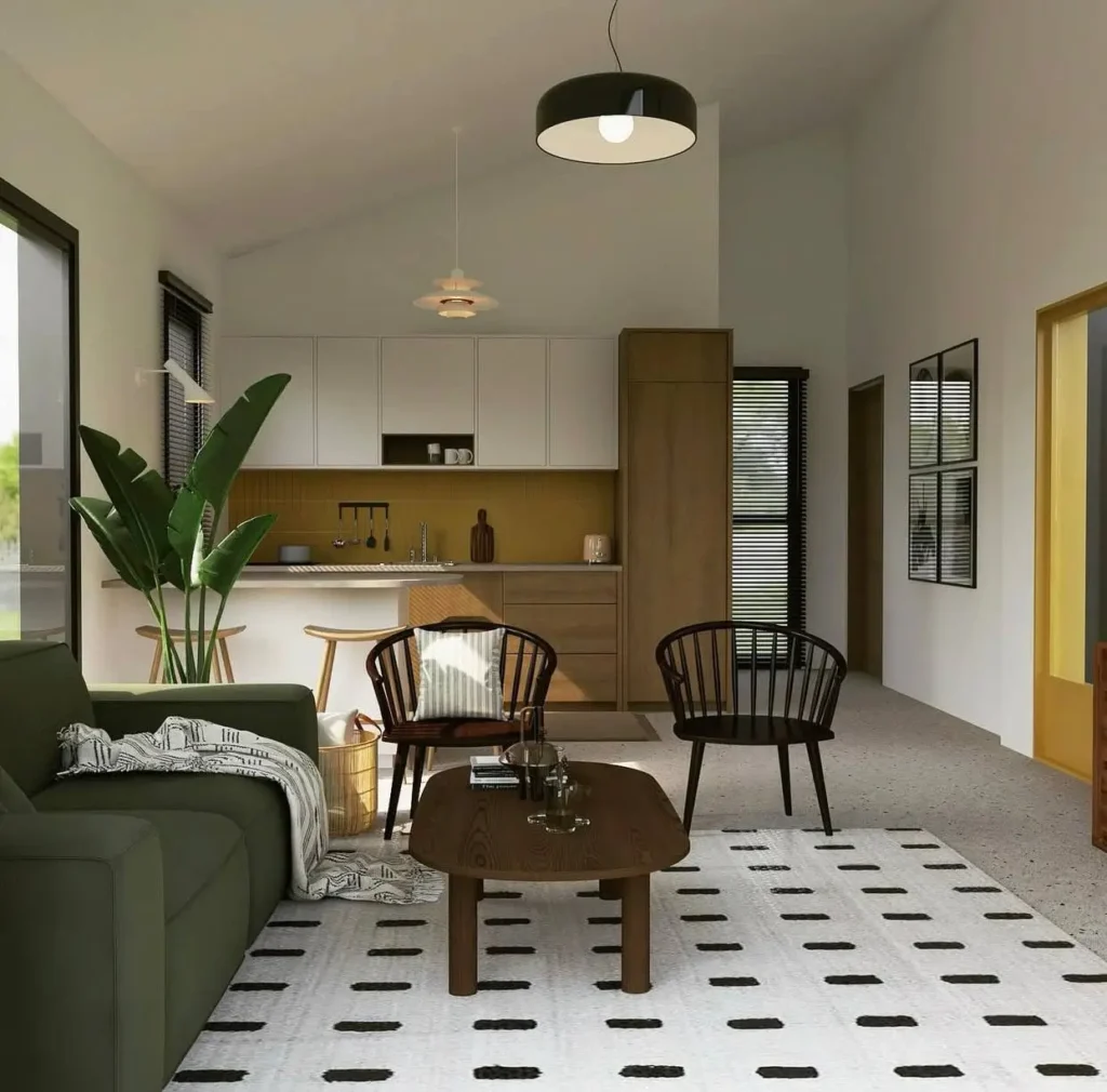 Open-plan minimalist living room with a green sofa, patterned rug, and a modern kitchen with a mustard backsplash.