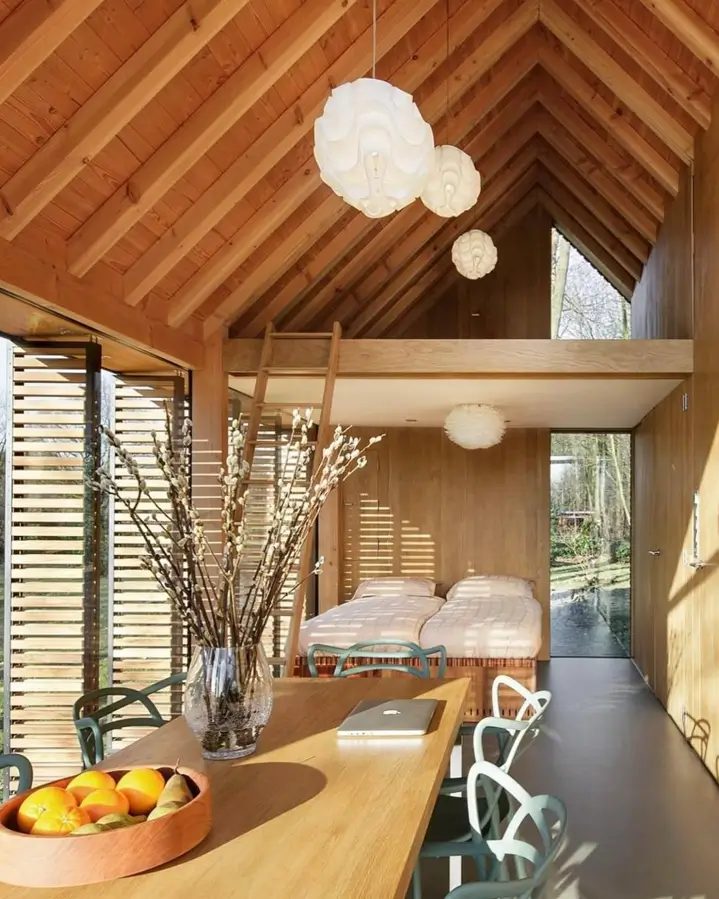 The Utrecht Cabin by Zecc Architects, a minimalist wood cabin in the Netherlands with movable shutters and glass walls.