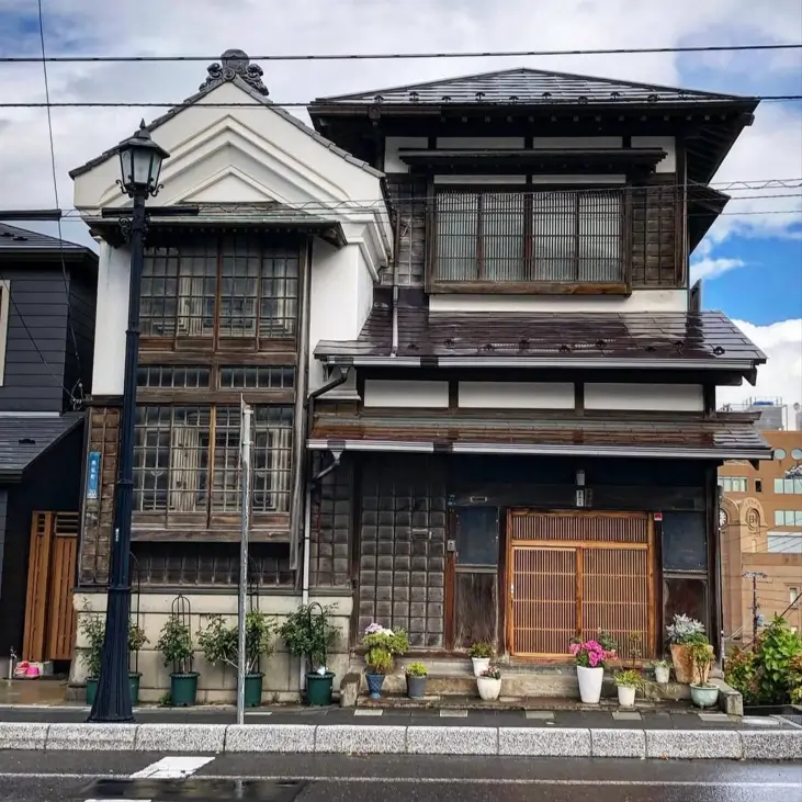 The 1917 Kusakabe family residence in Hakodate, a traditional Japanese machiya with a dark wood lattice facade.