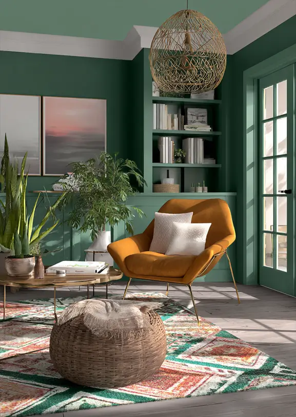Sophisticated sitting room with deep forest green walls and built-in shelving, accented by a mustard yellow armchair.