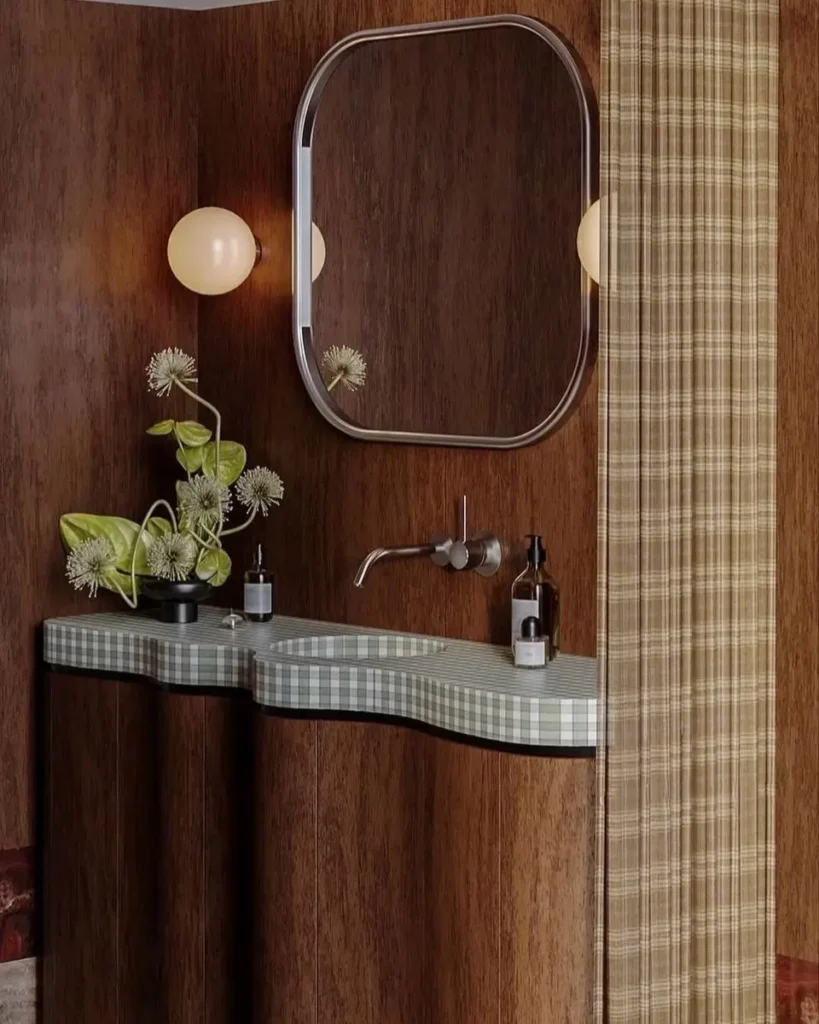 43 Mid Century Modern Small Bathroom Ideas for a Timeless Oasis (2025) 3 Curved wooden vanity with green checkered countertop in a mid century modern small bathroom.