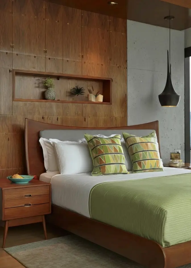 49 Headboard Design Ideas That Instantly Elevate Your Bedroom 12 Mid-century modern wooden headboard with grey insert against a wood paneled wall with built-in niche.