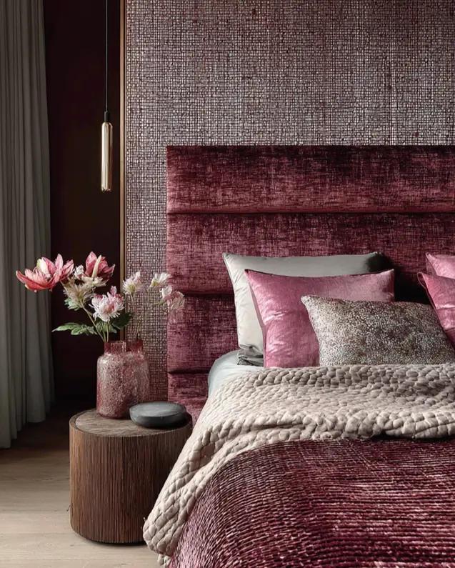 49 Headboard Design Ideas That Instantly Elevate Your Bedroom 13 Burgundy horizontal channel tufted velvet headboard against textured woven wallpaper with matching bedding.