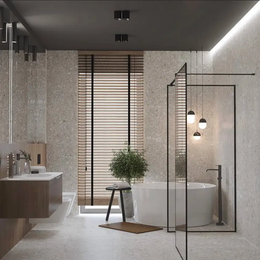 26 Japanese Bathroom Design Ideas for a Serene Home Oasis 13 A minimalist Japanese inspired bathroom with stone walls, a round white tub, and wooden blinds.