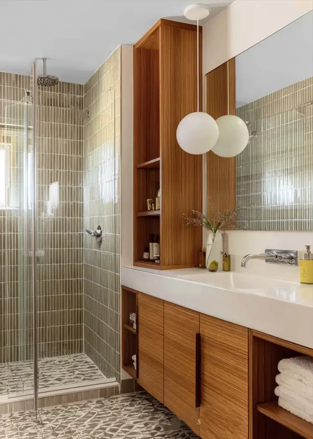 43 Mid Century Modern Small Bathroom Ideas for a Timeless Oasis (2025) 13 Vertical olive tiles and custom teak shelving in a mid century inspired bathroom.